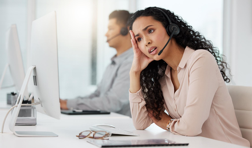 an irritated young woman who looks like a customer support agent
