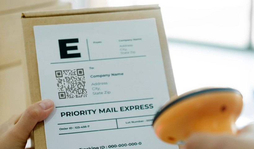 Hand scanning qr codes on shipping labels for package tracking.